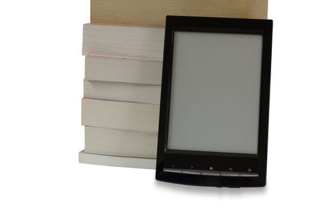 e-book reader in front of pile of books on white