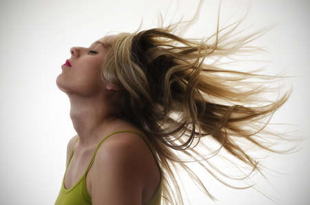 portrait of a woman with hair flying in the airの写真素材
