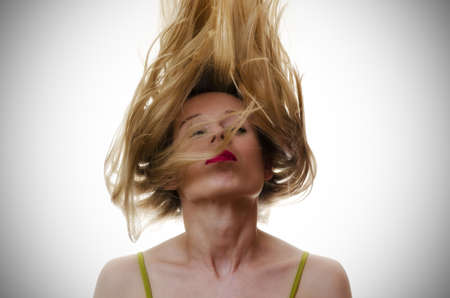 portrait of a woman with hair flying in the airの写真素材