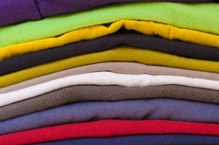 close up of a colorful stack of folded clothesの写真素材