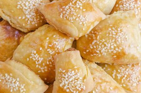 close-up background of freshly baked bread rolls sprinkled with sesameの写真素材