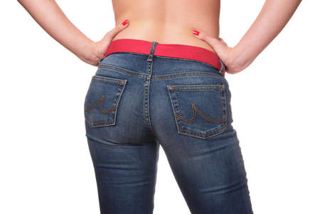 sexy woman holding hands on her waist wearing blue jeansの写真素材