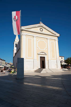 Porec, Croatia - Circa 2016: Church of our Lady of Angels with the flag of the town of Porec, Croatiaのeditorial素材