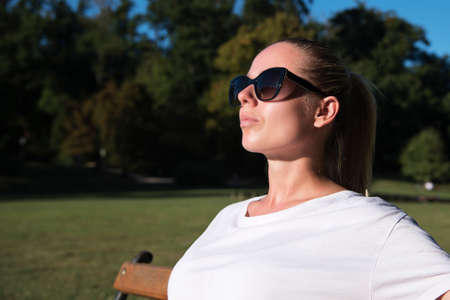 portrait of a woman out in the nature enjoying the bright sunsetの写真素材