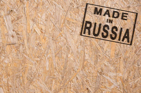 close-up of a brown pressed wood textured box with burn stamp Made in Russia on itの写真素材