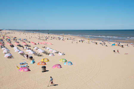Den Haag, Netherlands â July 2018: Crowded sandy beach during the warm summer day at Scheveningen located in the City of Den Haag, Netherlands.のeditorial素材