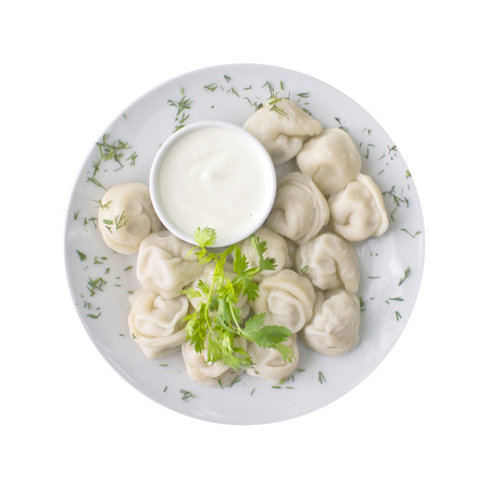 Ravioli and sauce on the plate, isolated on white background. Top viewの写真素材