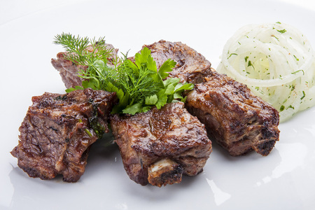 Skewers of pork ribs with onionsの写真素材