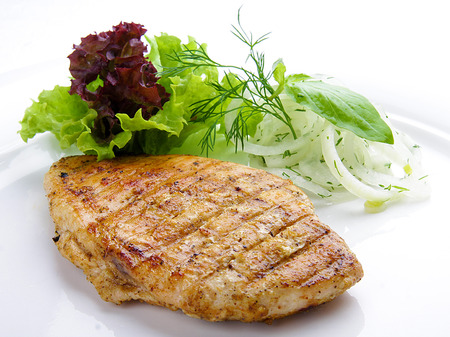 Steak from chicken with greens. On a white plateの写真素材