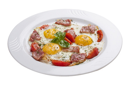 Scrambled eggs with ham and tomatoes on a white plateの写真素材