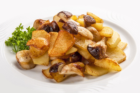 Fried potatoes with mushrooms on a white plate. Russian traditional dishの写真素材