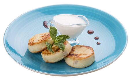 Breakfast. Cheesecakes with sour cream on a blue plateの写真素材