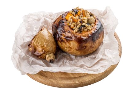 Pumpkin baked with perlotto and nuts. Vegetarian dish. On white backgroundの写真素材