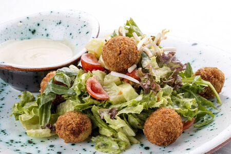 Salad with vegetable croquettes and . Vegetarian dish. On white backgroundの写真素材