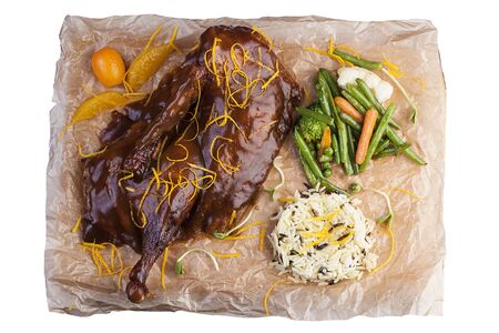 Duck leg in the glaze. On the board with parchment. On white backgroundの写真素材