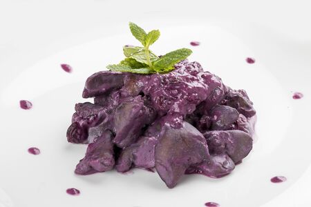 Chicken liver in colored sauce on white backgroundの写真素材