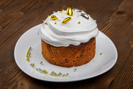 Easter cake kulich. Traditional Easter sweet bread decorated meringue and  candy cane shape eggs on...