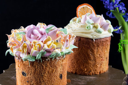 Various Spring Easter cakes with white icing and sugar decor on the table decorated in rustic style