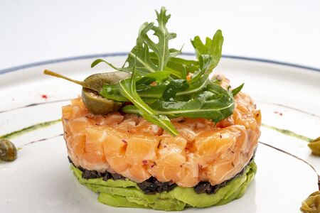 Tartar with salmon with arugula and avocado mousseの写真素材