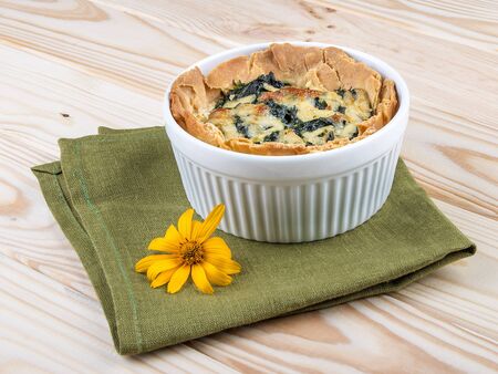 Casserole with broccoli and cheese, on a light wooden background. Takeaway. Diet and healthy food.の写真素材