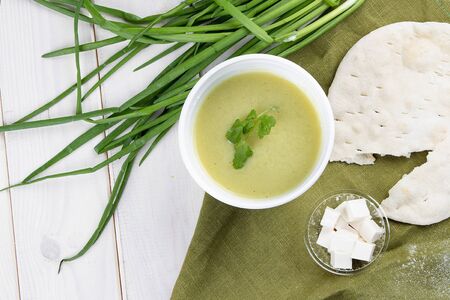 Cream broccoli soup with feta cheese and tortilla in containers on a white background. Takeaway. Diet and healthy food.の写真素材