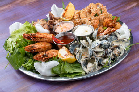 Seafood set. Langoustines, prawns, mussels, squid, octopus and saucesの写真素材