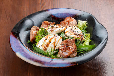 Duck breast salad with cream cheese and arugula. In a decorative plateの写真素材