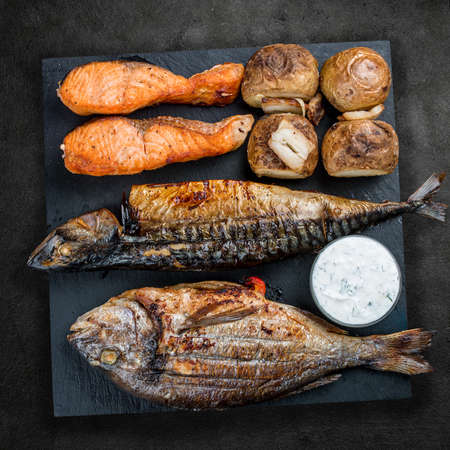 Assorted delicious grilled meat on a stone board. Top viewの写真素材