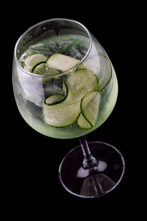 Martini cocktail, tonic and cucumber on a dark background. Isolatedの写真素材