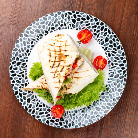 Fresh chicken roll with fresh tomatos, salad, cheese and onions. Shaurma, shawerma, fajita