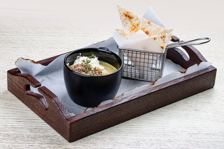 Onion cappuccino soup with amaranth and camembert cheese.