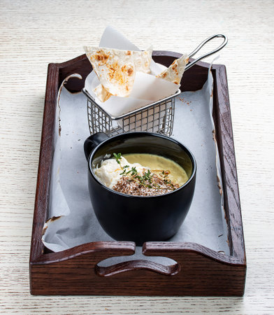 Onion cappuccino soup with amaranth and camembert cheese.の写真素材