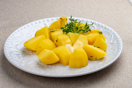 Boiled slices of potatoes with herbs.の写真素材
