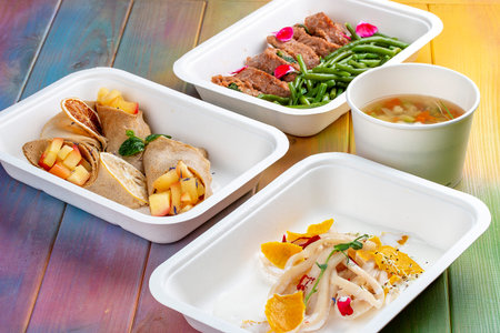 A set of healthy food dishes in ecological packaging on a wooden background. food delivery. takeaway.の写真素材