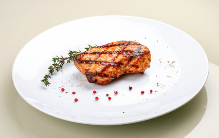 Grilled chicken breast on white backgroundの写真素材
