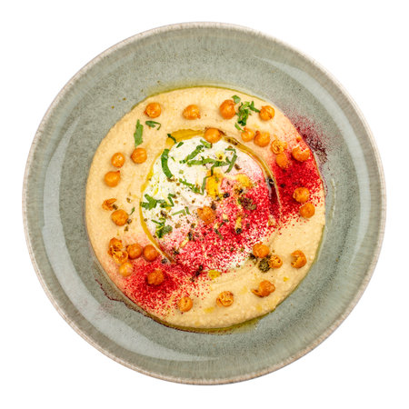 Chickpea hummus on a decorative ceramic plate. white background.の写真素材