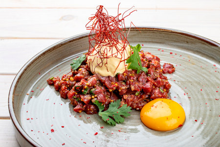 Veal tartare with jelly and mustard. Haute cuisine. On a wooden background.の写真素材