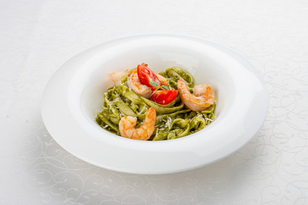 Fettuccini with shrimp and pesto sauce. Isolated imageの写真素材