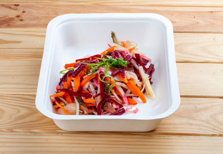Vinigret salad. Vegetarian food. Takeaway food. On a wooden background.の写真素材