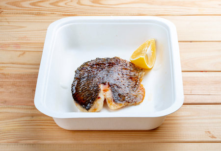 Sea bass fillet. Healthy food. Takeaway food. On a wooden background.