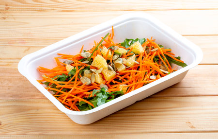 Carrot salad with orange. Healthy food. Takeaway food. On a wooden background.の写真素材