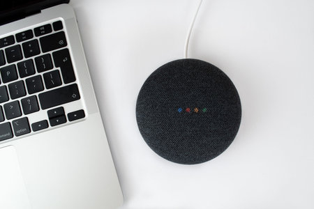London, United Kingdom - 19 December 2020: Charcoal Google Nest Home Mini smart speaker with built...