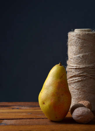 Pear and coil thread on a gray backgroundの写真素材
