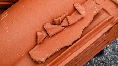 Red ceramic tiles on the roof of the house, closeup of photoの写真素材