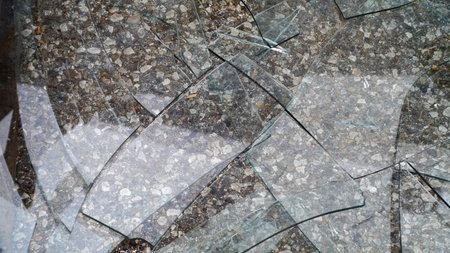 Broken glass on the ground as an abstract background for design.