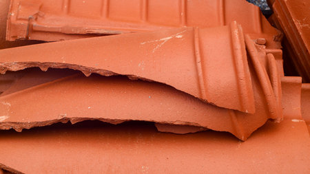 Closeup of a pile of red clay tiles in a construction siteの写真素材