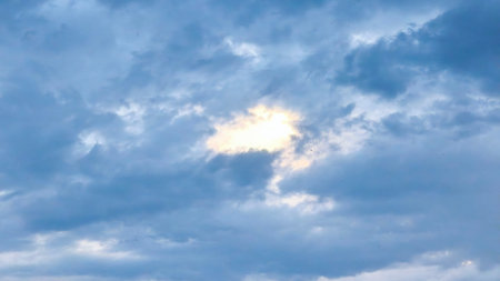 Clouds in the blue sky at sunset as an abstract background.の写真素材