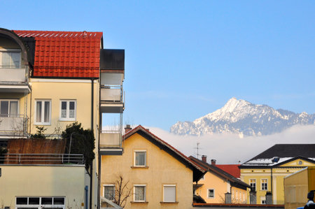 Yellow houses with a mountain in the background.