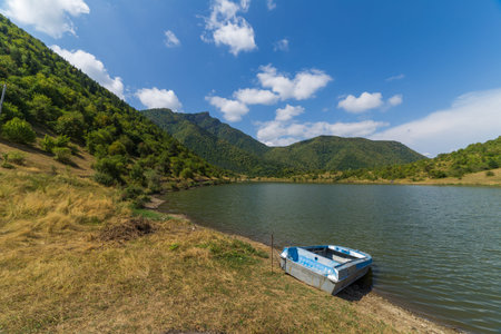 lake with boat at mountains