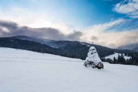 Big reap on snowy hill on mountain backgroundの写真素材